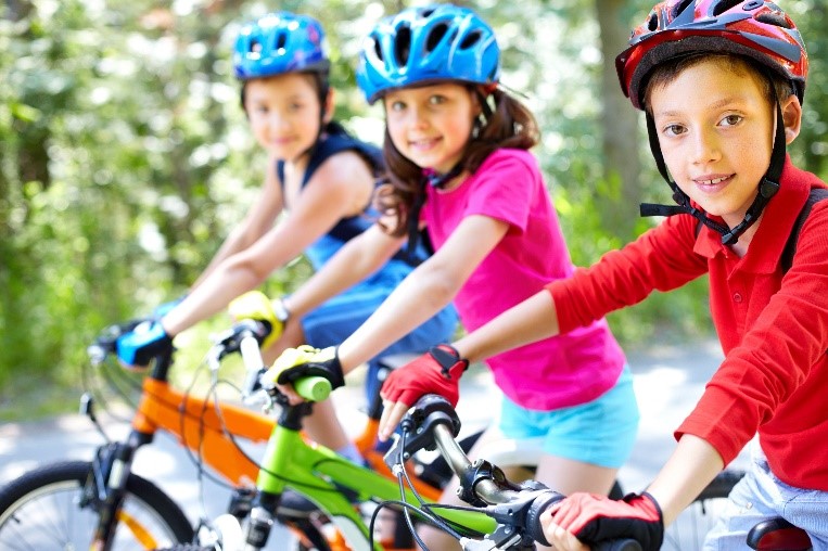 kids with helmets on bike